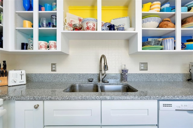 kitchen featuring white cabinets, dishwashing machine, decorative backsplash, and sink