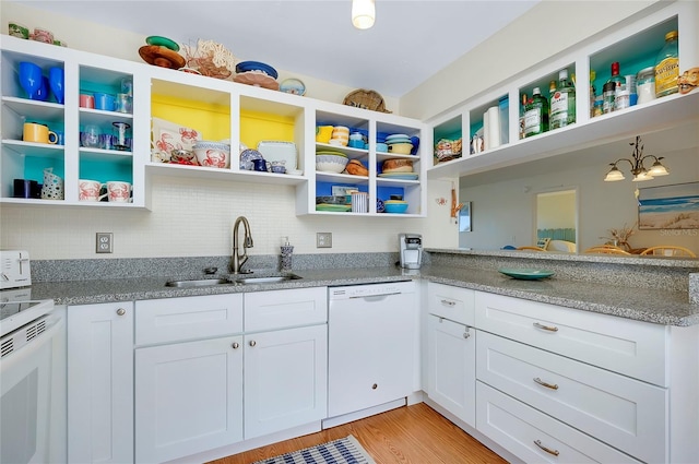 kitchen with light wood-type flooring, light stone counters, white appliances, sink, and white cabinets