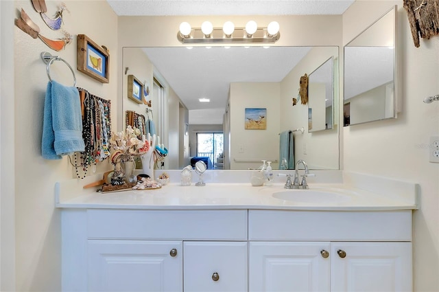 bathroom featuring a textured ceiling and vanity