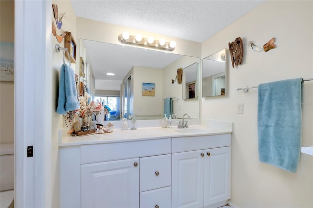 bathroom with vanity and a textured ceiling