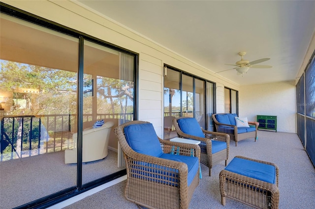 sunroom / solarium featuring ceiling fan