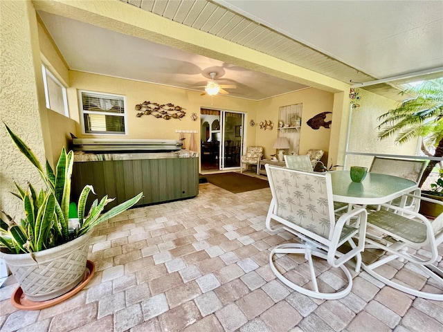 sunroom featuring ceiling fan