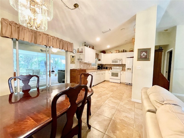 tiled dining room with high vaulted ceiling and a notable chandelier