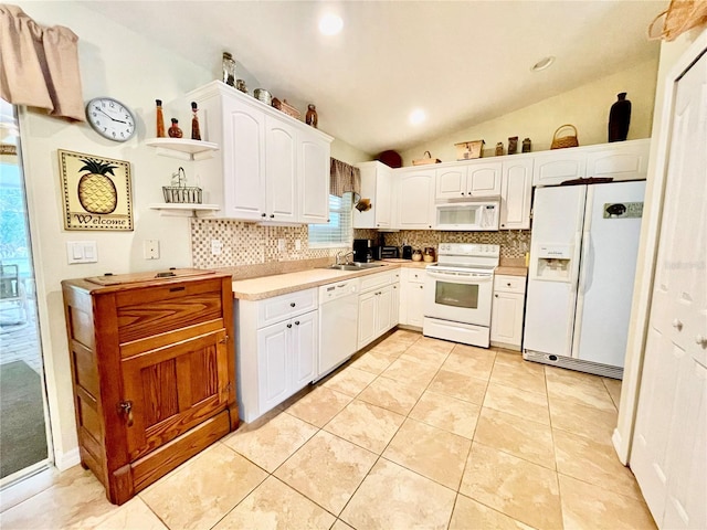 kitchen with white cabinets, white appliances, tasteful backsplash, and lofted ceiling