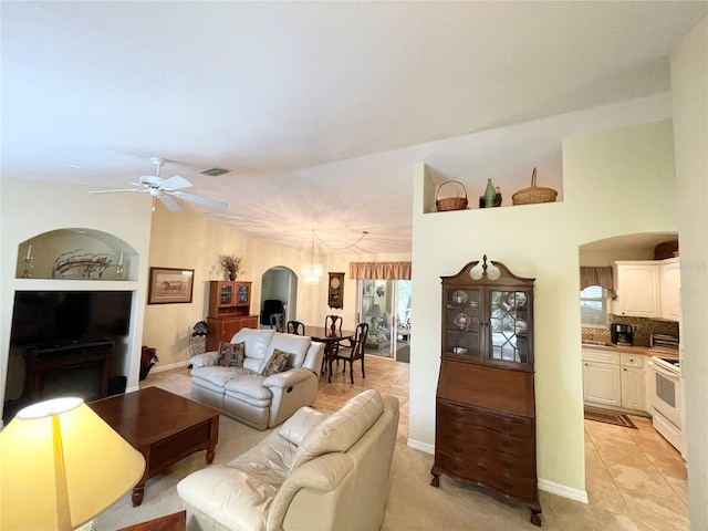 tiled living room featuring ceiling fan