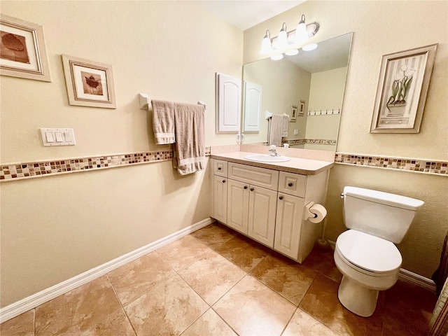 bathroom with tile patterned flooring, vanity, and toilet