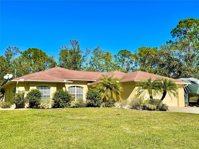 ranch-style home featuring a front lawn and a garage