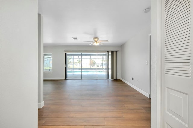 empty room with ceiling fan and wood-type flooring