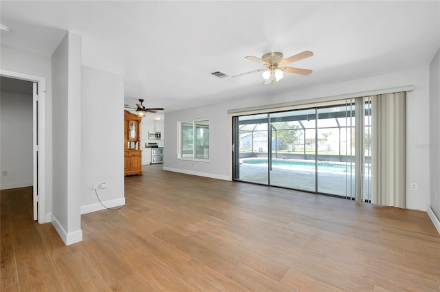 unfurnished living room featuring ceiling fan and light hardwood / wood-style flooring