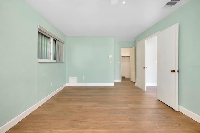 unfurnished room with light wood-type flooring