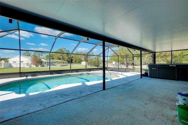 view of swimming pool with a patio area, a lanai, and a hot tub