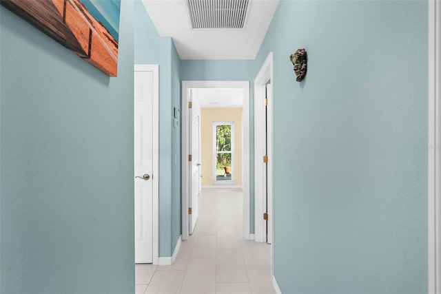 corridor featuring light tile patterned floors