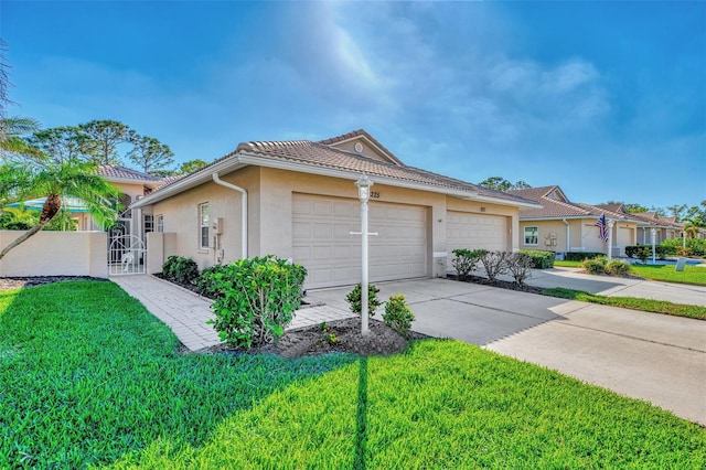 view of front of home with a garage and a front lawn