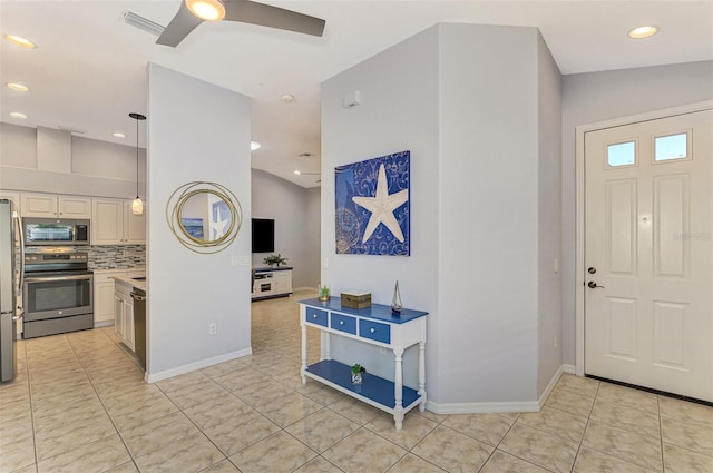 entrance foyer featuring vaulted ceiling, ceiling fan, and light tile patterned flooring