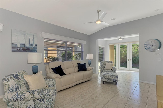 tiled living room featuring ceiling fan, french doors, and lofted ceiling