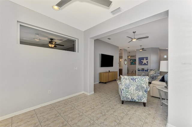 living room with ceiling fan and light tile patterned flooring