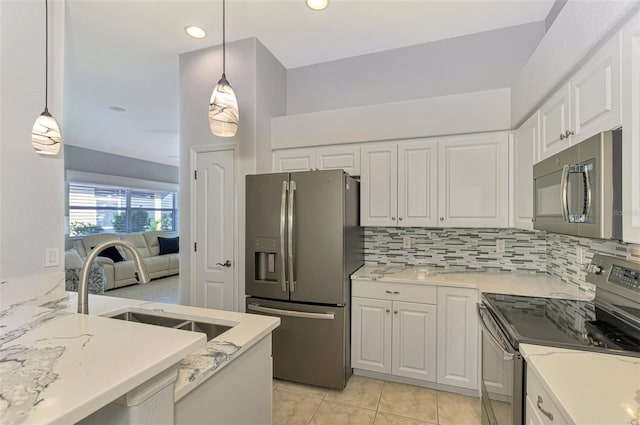 kitchen featuring white cabinets, appliances with stainless steel finishes, pendant lighting, and sink