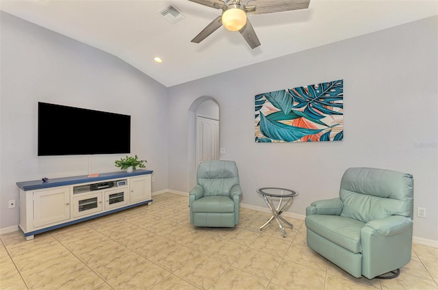 sitting room featuring ceiling fan, light tile patterned flooring, and vaulted ceiling