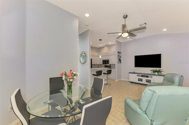 living room with ceiling fan and vaulted ceiling