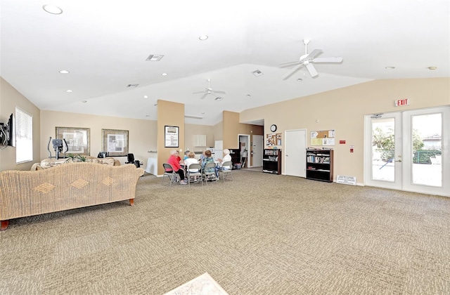 carpeted living room with french doors, vaulted ceiling, and ceiling fan