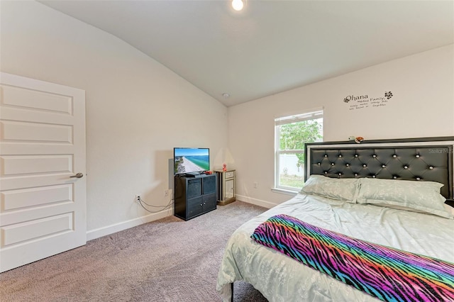 carpeted bedroom featuring vaulted ceiling