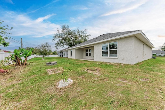 rear view of house with a yard