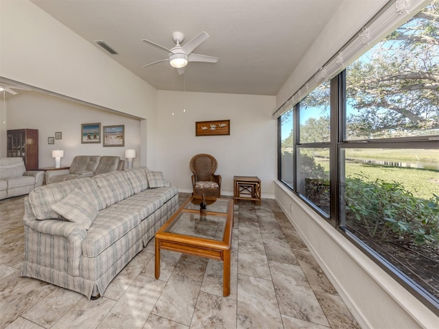 living room featuring ceiling fan and vaulted ceiling