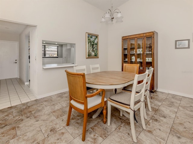 dining space featuring a chandelier and high vaulted ceiling