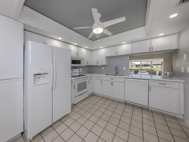 kitchen featuring sink, white appliances, and white cabinets