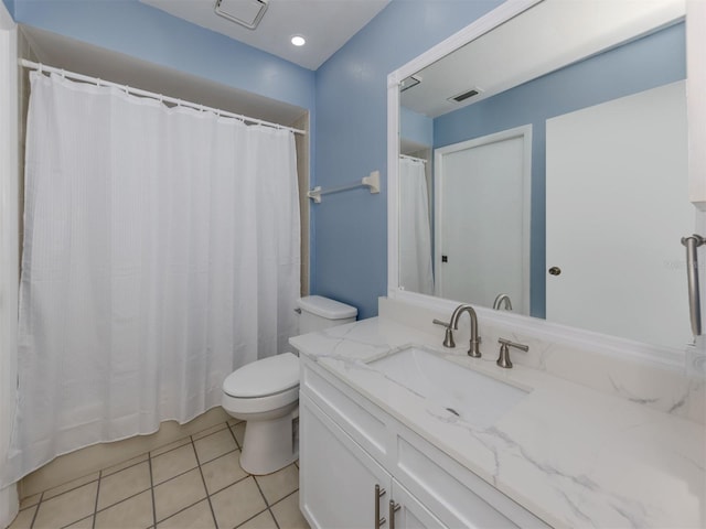 bathroom featuring tile patterned flooring, vanity, and toilet