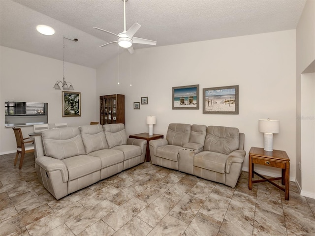 living room featuring ceiling fan, vaulted ceiling, and a textured ceiling