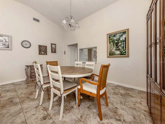 dining space featuring an inviting chandelier and lofted ceiling