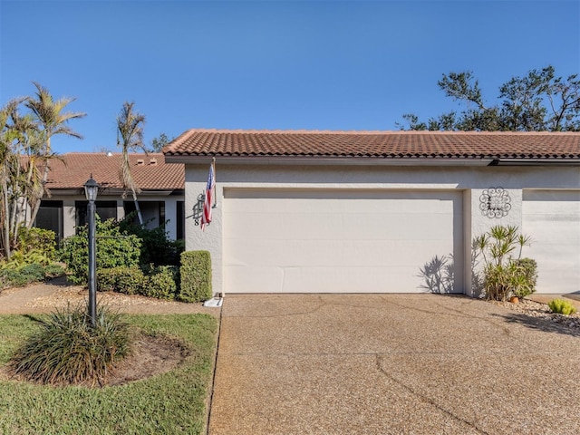 mediterranean / spanish home with a garage