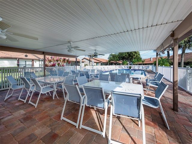 view of patio / terrace with ceiling fan and a community pool