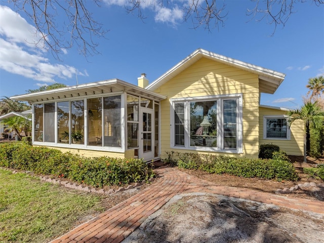 back of house featuring a sunroom