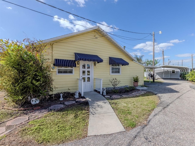 bungalow with a carport and a front yard