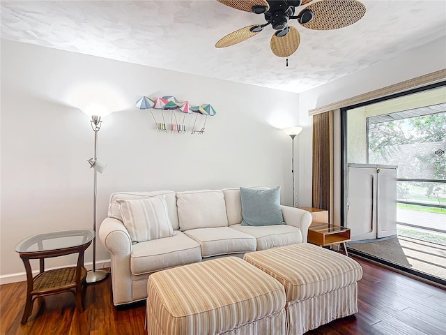 living room with ceiling fan and dark wood-type flooring