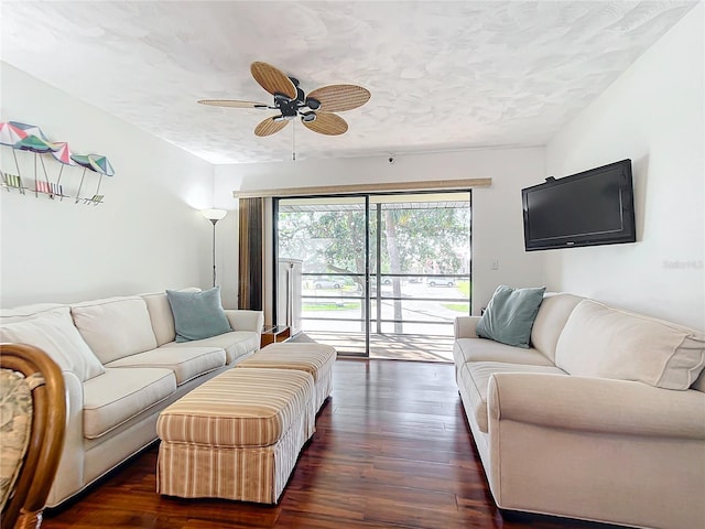 living room featuring a textured ceiling, dark hardwood / wood-style flooring, and ceiling fan