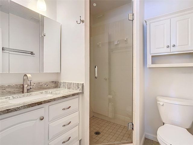 bathroom featuring an enclosed shower, vanity, and toilet