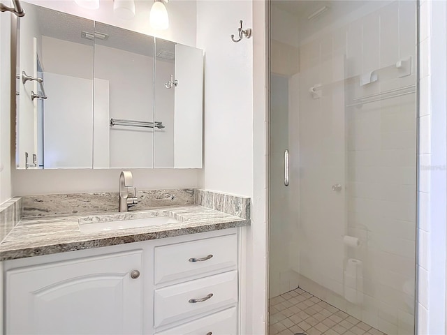 bathroom featuring vanity and a shower with shower door