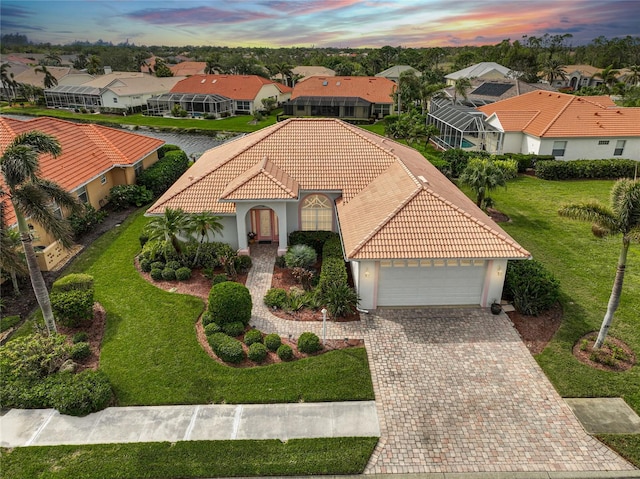 view of front of home featuring a lawn and a garage