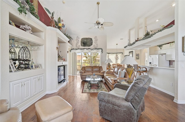 living room featuring dark hardwood / wood-style floors and ceiling fan