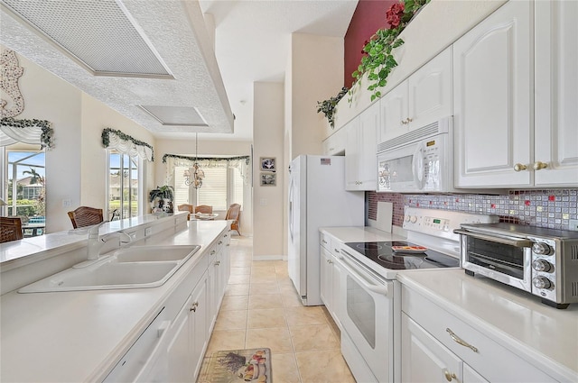 kitchen with white cabinetry, sink, backsplash, white appliances, and light tile patterned flooring