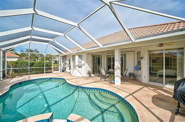 view of swimming pool featuring a patio, ceiling fan, and a lanai