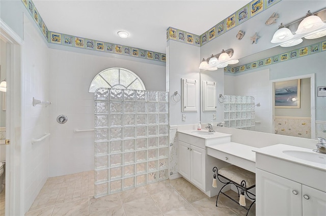 bathroom featuring tiled shower, vanity, and tile patterned floors