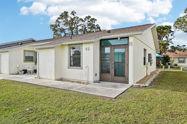 back of property featuring a patio area and a yard