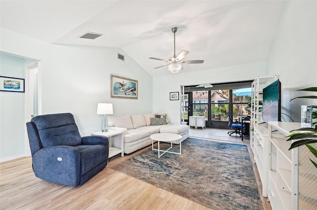 living room featuring light hardwood / wood-style floors, vaulted ceiling, and ceiling fan