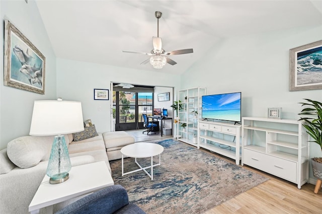 living room with ceiling fan, wood-type flooring, and vaulted ceiling