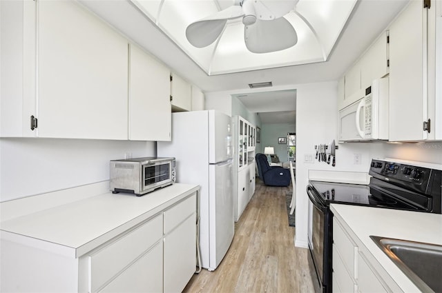 kitchen featuring white cabinets, ceiling fan, light hardwood / wood-style floors, and white appliances