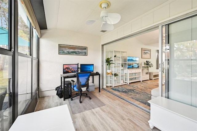 office space with light wood-type flooring, ceiling fan, and lofted ceiling